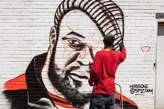 Graffiti artist Meres One paints a mural memorializing Sean Price in Crown Heights one day after his unexpected death in 2015.